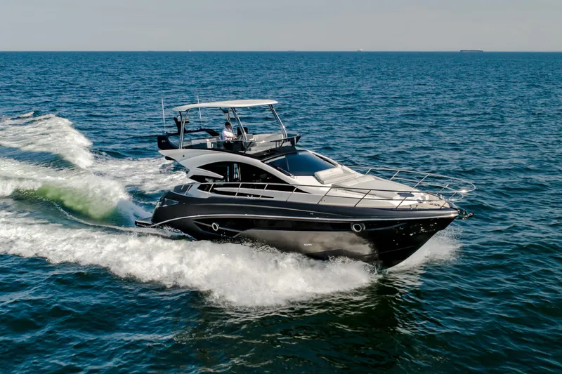 The Image of 2026 Cobrey 52 FLY yacht cruising on open sea, showcasing sleek design and luxury features. - 0