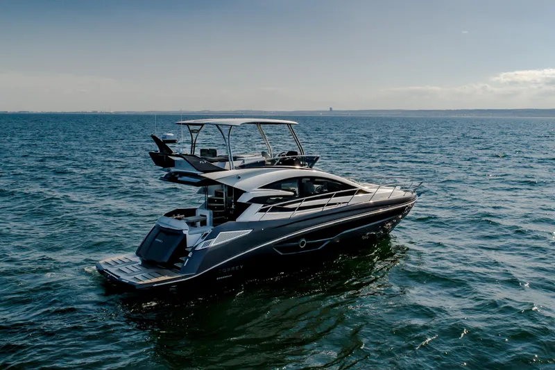 Slide: The Image of 2026 Cobrey 52 FLY yacht cruising on open water under clear skies. - 4