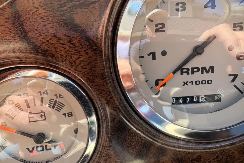Slide: The Image of Close-up of 1997 Stingray 200 CS dashboard gauges showing RPM and voltage readings. - 11