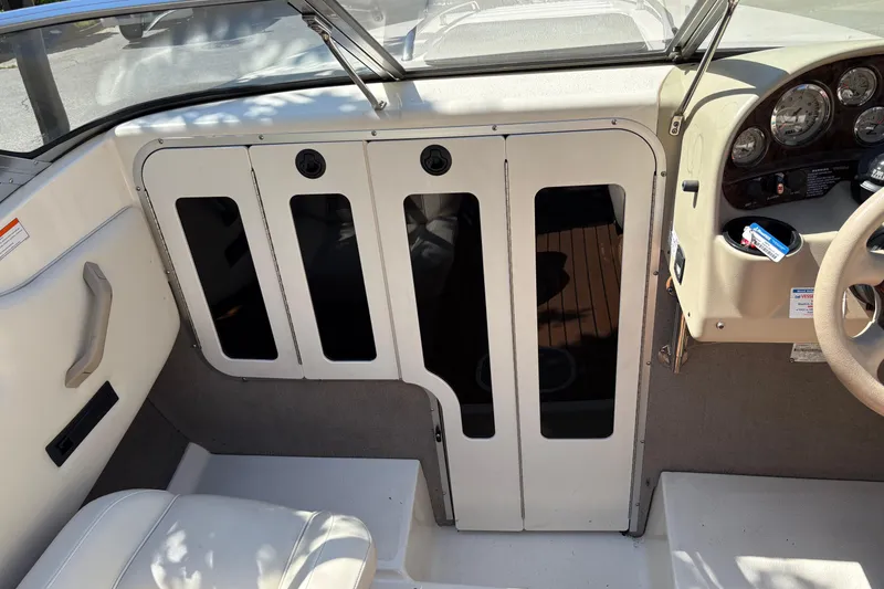 Slide: The Image of 1997 Stingray 200 CS boat interior with dashboard and seating area. - 14