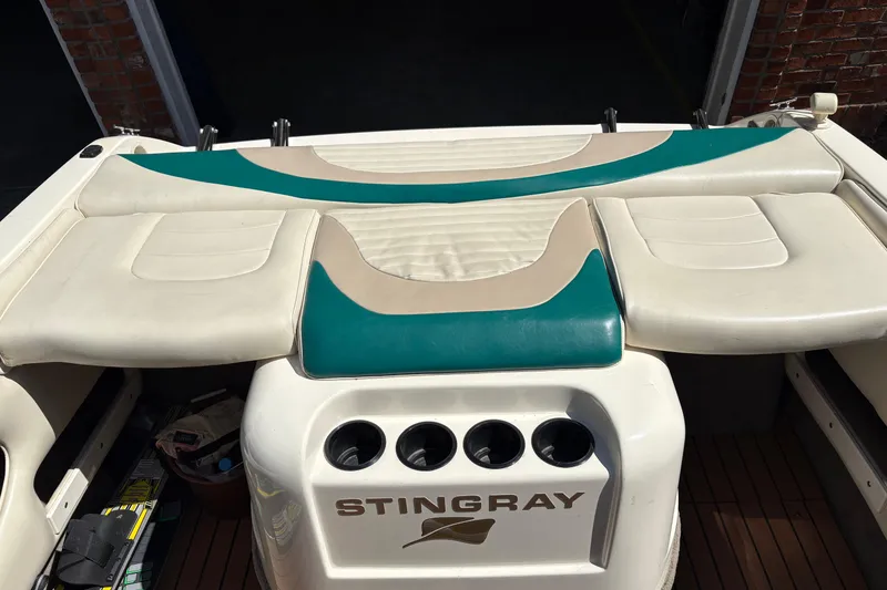Slide: The Image of 1997 Stingray 200 CS boat interior with beige and teal seating. - 16