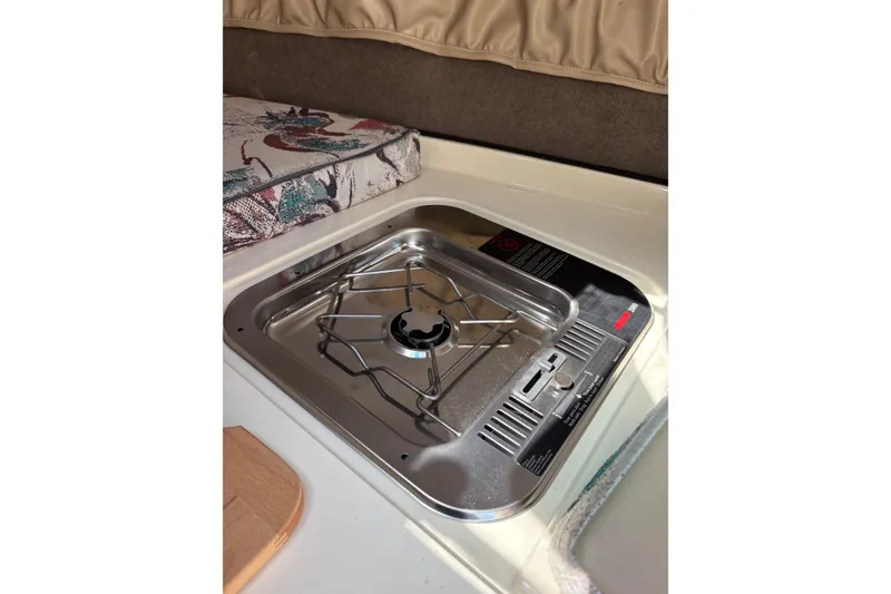 Slide: The Image of Compact stove in 1997 Stingray 200 CS boat interior, featuring a single burner setup. - 21