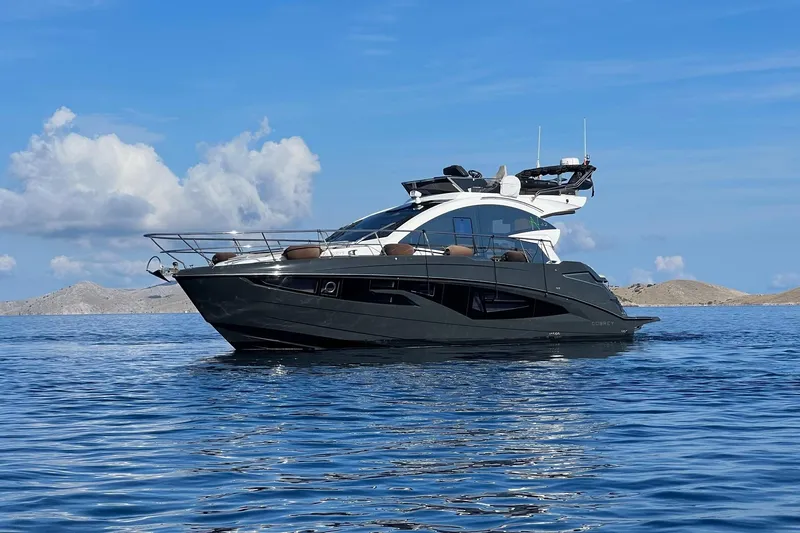 The Image of Luxurious 2026 Cobrey 45 FLY yacht cruising on serene blue waters. - 0