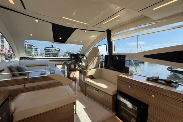 Slide: The Image of Luxurious interior of 2026 Cobrey 45 FLY yacht with modern furnishings and scenic marina view. - 10