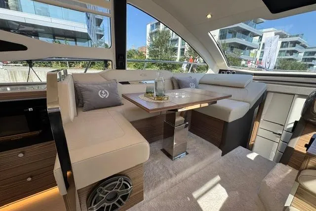 Slide: The Image of Luxurious interior of 2026 Cobrey 45 FLY yacht with elegant seating and modern design. - 11