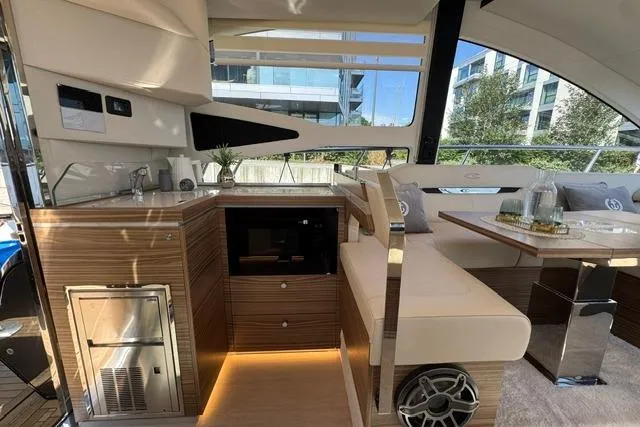 Slide: The Image of Luxurious interior of 2026 Cobrey 45 FLY yacht with modern kitchen and seating area. - 13