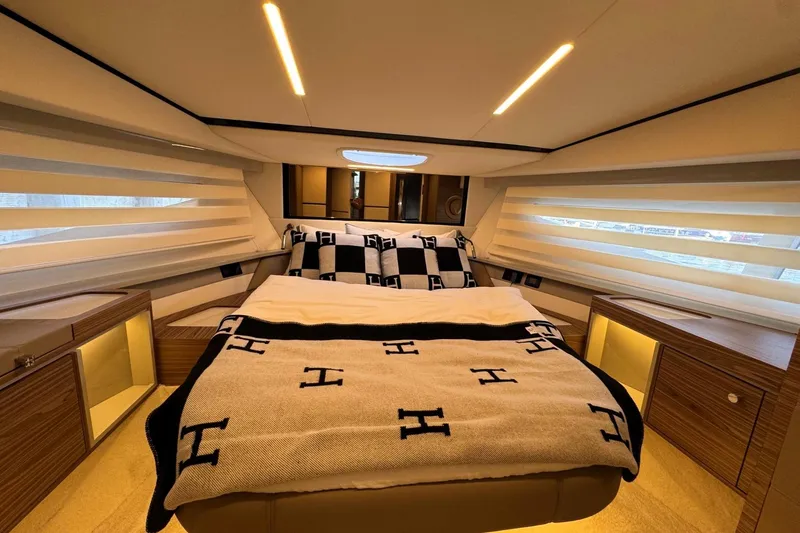 Slide: The Image of Luxurious bedroom interior of 2026 Cobrey 45 FLY yacht with elegant bedding and ambient lighting. - 15