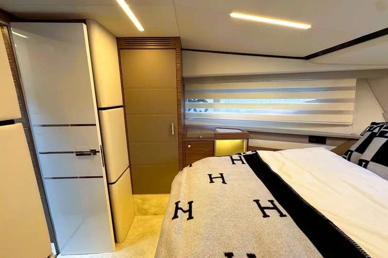 Slide: The Image of Luxurious interior of 2026 Cobrey 45 FLY yacht bedroom with modern design and elegant furnishings. - 16