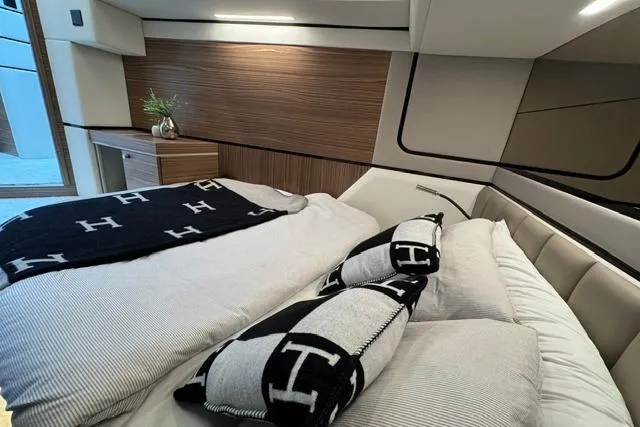 Slide: The Image of Luxurious bedroom interior of 2026 Cobrey 45 FLY yacht with modern design and cozy bedding. - 19
