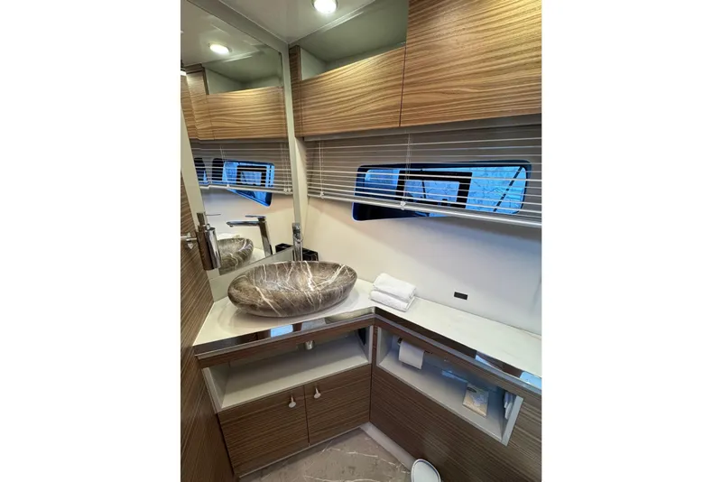 Slide: The Image of Luxurious bathroom interior of 2026 Cobrey 45 FLY yacht with modern sink and wooden cabinetry. - 23