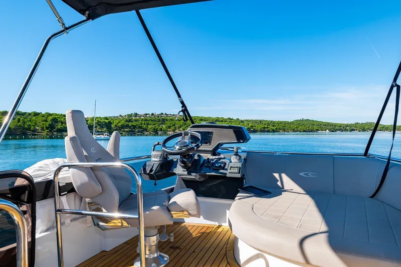 Slide: The Image of Flybridge of 2026 Cobrey 45 FLY yacht with scenic water view. - 5