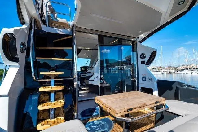 Slide: The Image of Luxurious 2026 Cobrey 45 FLY yacht interior with modern design and marina view. - 6