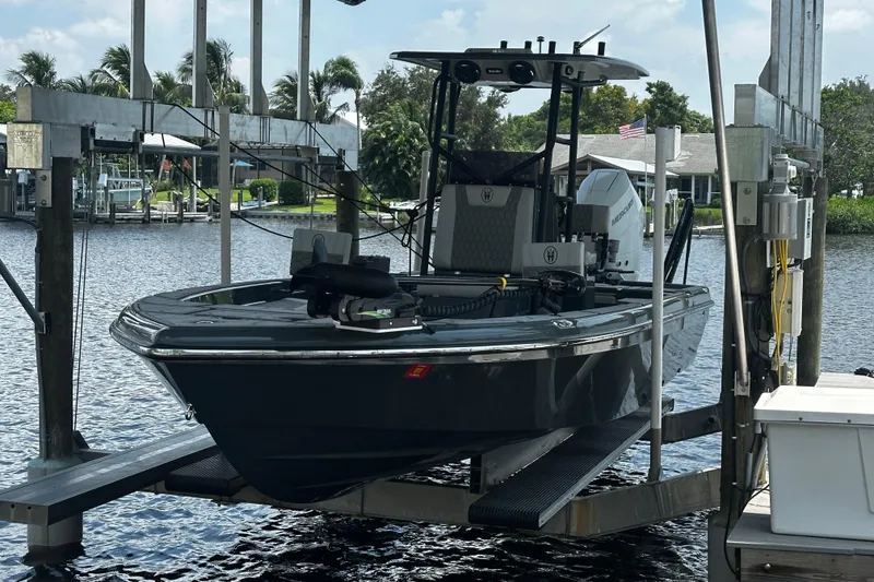 Slide: The Image of 2024 H-Craft 27 CC boat on lift by waterfront dock. - 11