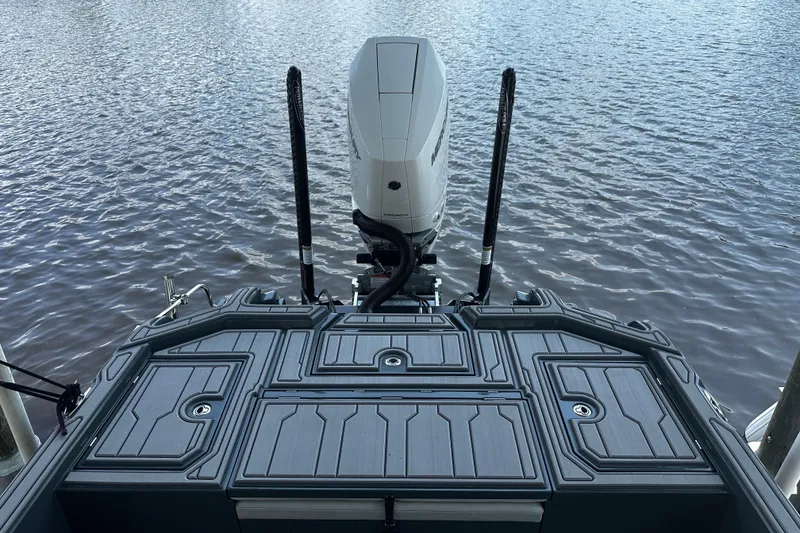Slide: The Image of 2024 H-Craft 27 CC boat with outboard motor on calm water. - 12
