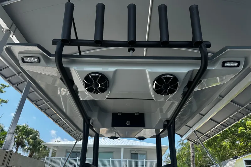 Slide: The Image of 2024 H-Craft 27 CC boat with speakers and rod holders under canopy. - 24