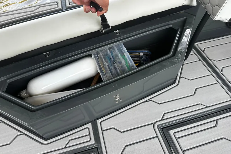 Slide: The Image of 2024 H-Craft 27 CC boat storage compartment with safety equipment and accessories. - 40