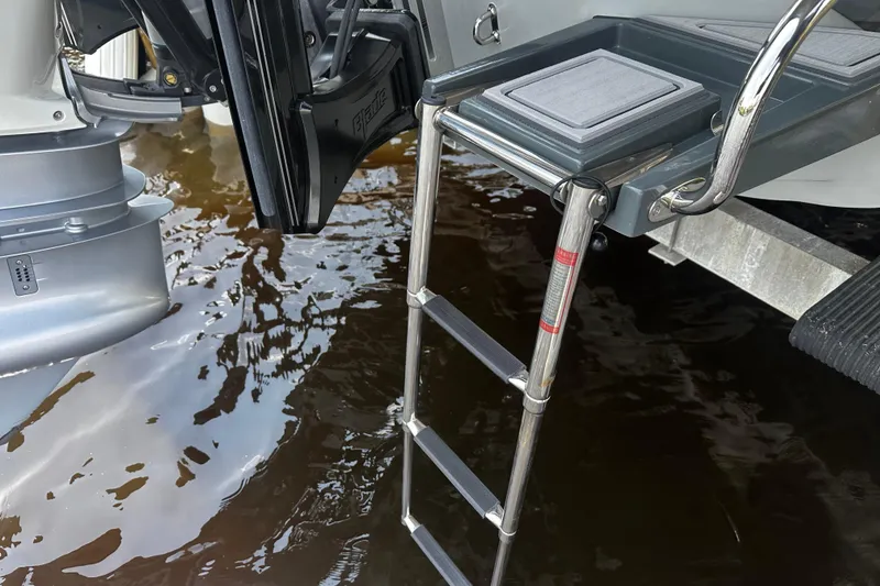 Slide: The Image of 2024 H-Craft 27 CC boat ladder and motor in water. - 44