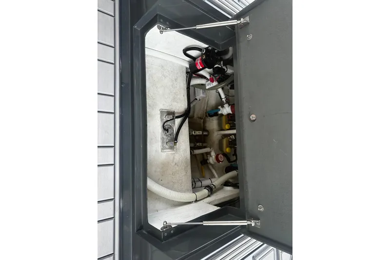 Slide: The Image of 2024 H-Craft 27 CC boat compartment with visible wiring and plumbing components. - 45