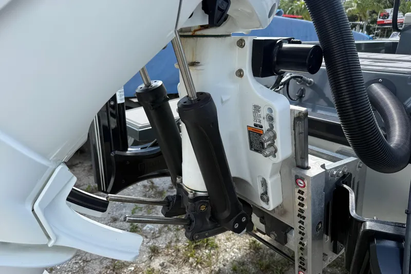Slide: The Image of 2024 H-Craft 27 CC boat engine detail with hydraulic components and mounting bracket. - 46