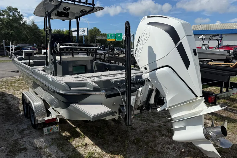 Slide: The Image of 2024 H-Craft 27 CC boat with powerful outboard motor, parked on a trailer. - 5