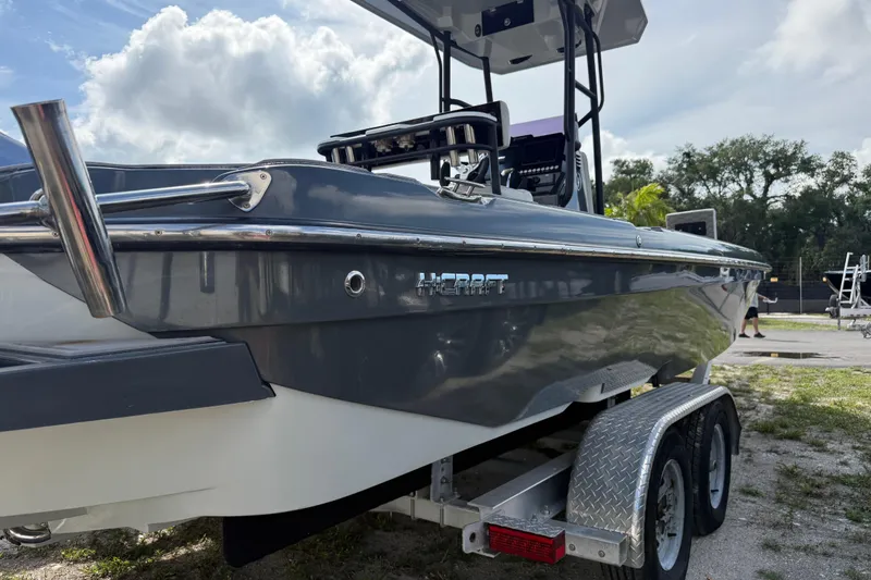 Slide: The Image of 2024 H-Craft 27 CC boat on trailer, sleek design under cloudy sky. - 9