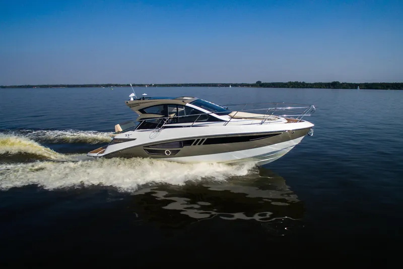 Slide: The Image of 2026 Cobrey 33 HT yacht cruising on a calm lake under a clear blue sky. - 3