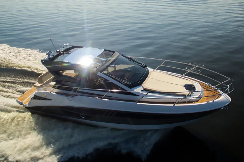 Slide: The Image of 2026 Cobrey 33 HT yacht cruising on calm waters, showcasing sleek design and luxury features. - 4