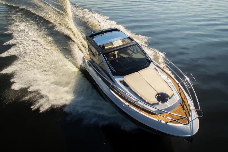 Slide: The Image of 2026 Cobrey 33 HT yacht cruising on calm water, showcasing sleek design and performance. - 5