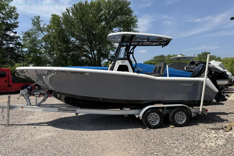 Slide: The Image of 2020 Tidewater 232 CC Adventure boat on trailer, parked outdoors. - 1
