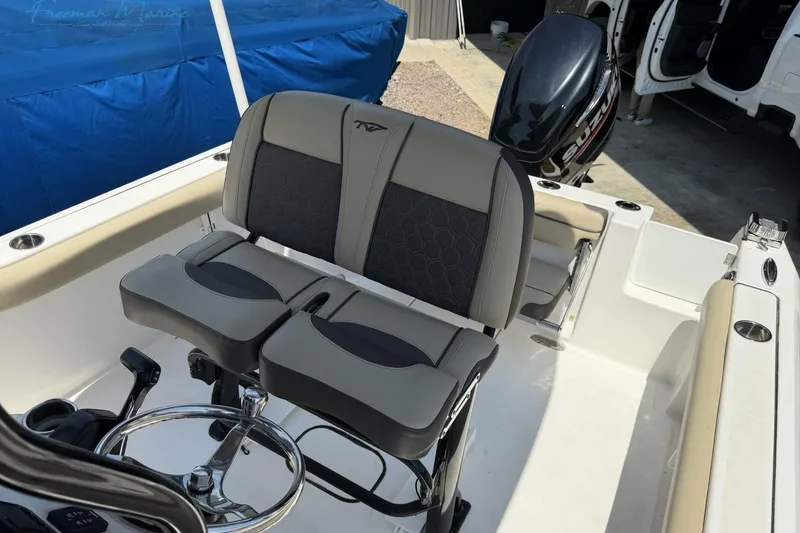 Slide: The Image of 2020 Tidewater 232 CC Adventure boat interior with dual seats and Suzuki outboard motor. - 10