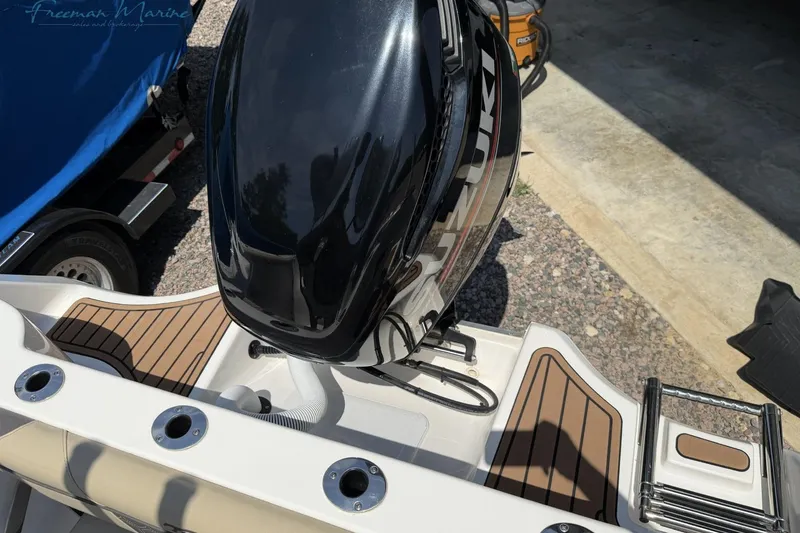 Slide: The Image of 2020 Tidewater 232 CC Adventure boat with Suzuki outboard motor, docked on gravel. - 17