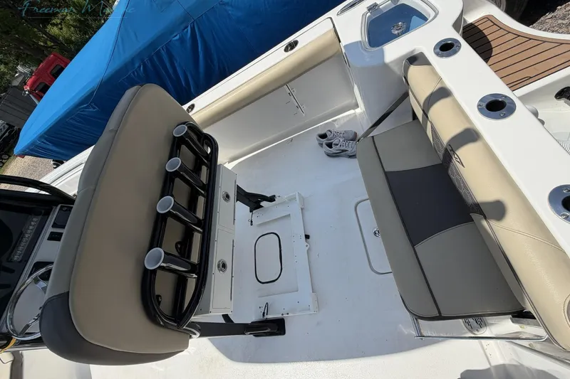Slide: The Image of 2020 Tidewater 232 CC Adventure boat interior with seating and rod holders. - 19