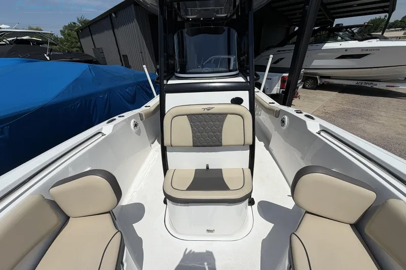 Slide: The Image of 2020 Tidewater 232 CC Adventure boat interior with beige seating and modern design. - 6
