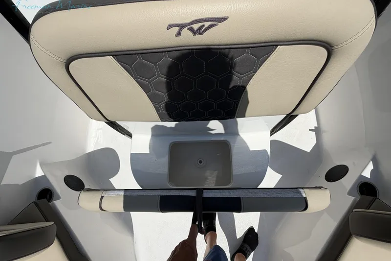 Slide: The Image of 2020 Tidewater 232 CC Adventure boat interior with beige and black seating. - 8