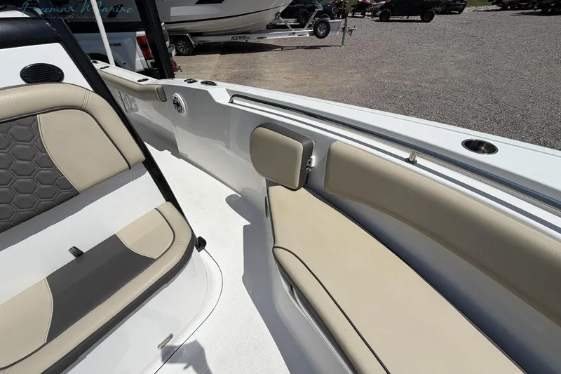 Slide: The Image of 2020 Tidewater 232 CC Adventure boat interior with beige seating and cup holder. - 9