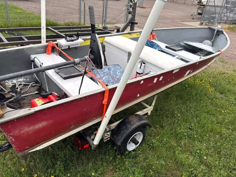 Slide: The Image of A red boat on a trailer, featuring blue seats and equipment on board. - 2