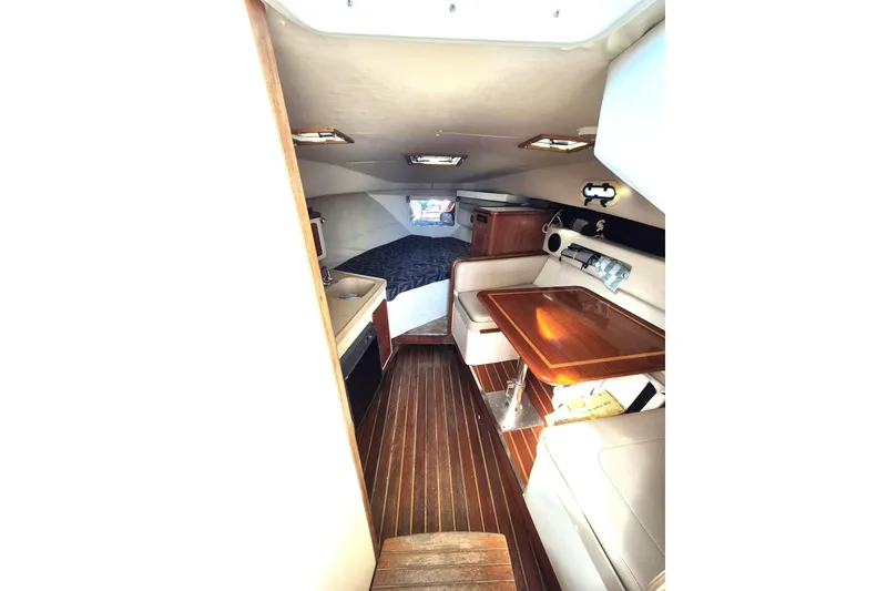 Slide: The Image of 2002 Pursuit 3000 Express cabin interior with wood flooring and seating area. - 6