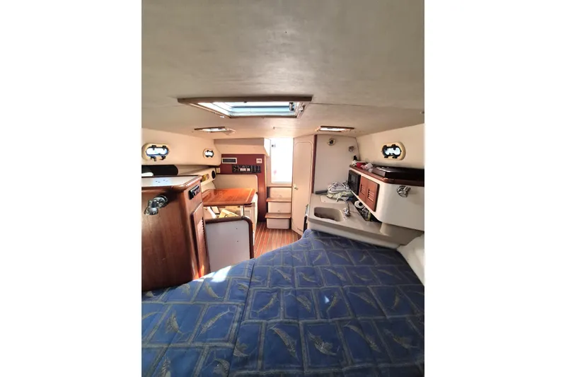 Slide: The Image of Interior of 2002 Pursuit 3000 Express boat with cozy cabin and wooden accents. - 7