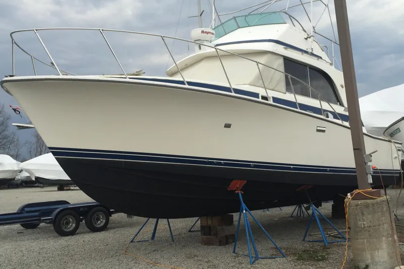 The Image of 1985 Bertram 33 Flybridge Cruiser on stands, ready for maintenance. - 0