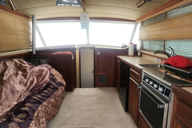 Slide: The Image of Interior of 1985 Bertram 33 Flybridge Cruiser with kitchen and cozy sleeping area. - 10
