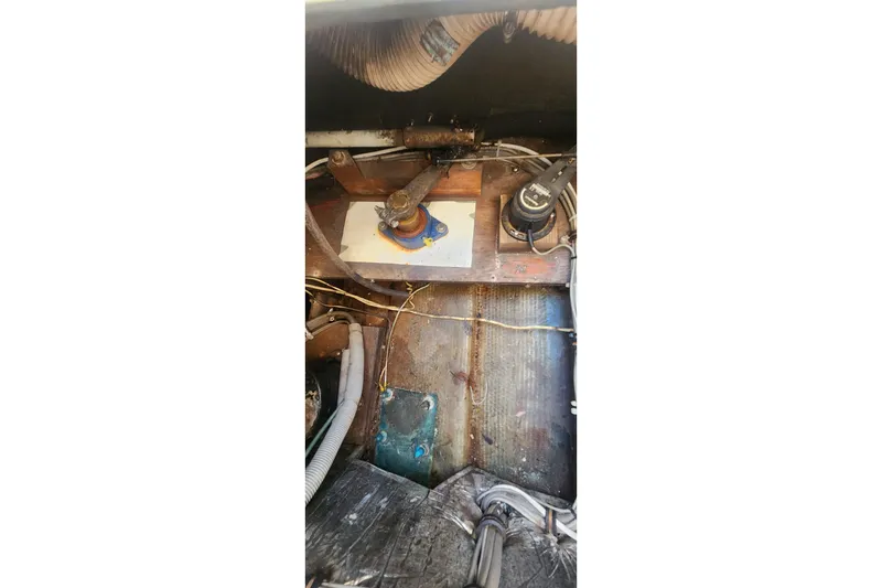 Slide: The Image of Engine compartment of a 1985 Bertram 33 Flybridge Cruiser, showing mechanical components and wiring. - 11