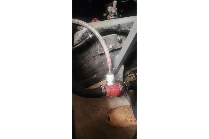 Slide: The Image of Engine compartment of a 1985 Bertram 33 Flybridge Cruiser showing hoses and fittings. - 14