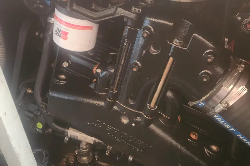Slide: The Image of Engine compartment of a 1985 Bertram 33 Flybridge Cruiser, featuring a Mercury engine. - 34