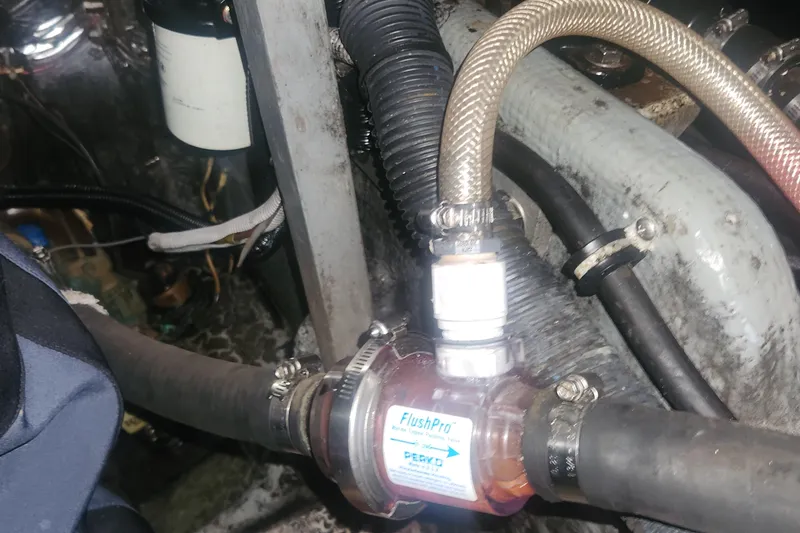 Slide: The Image of Engine compartment of a 1985 Bertram 33 Flybridge Cruiser with visible hoses and fittings. - 37