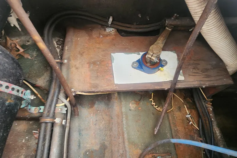 Slide: The Image of Engine compartment of a 1985 Bertram 33 Flybridge Cruiser, showing mechanical components and wiring. - 38