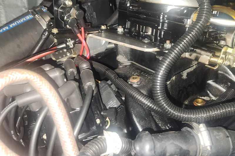 Slide: The Image of Engine components of a 1985 Bertram 33 Flybridge Cruiser, showcasing wiring and mechanical parts. - 41