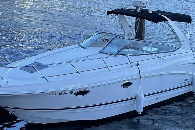 The Image of 2006 Chaparral 290 Signature boat docked on water with black canopy. - 0