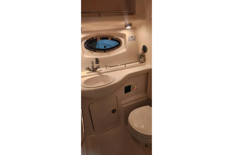 Slide: The Image of Bathroom interior of 2006 Chaparral 290 Signature boat, featuring sink and toilet. - 18