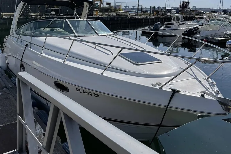 Slide: The Image of 2006 Chaparral 290 Signature boat docked at a marina, side view. - 3
