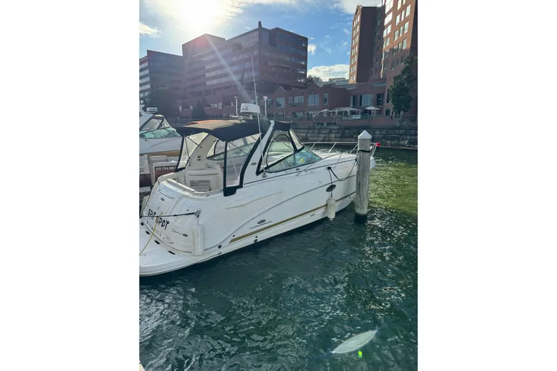 Slide: The Image of 2006 Chaparral 290 Signature boat docked in urban marina under sunny sky. - 5